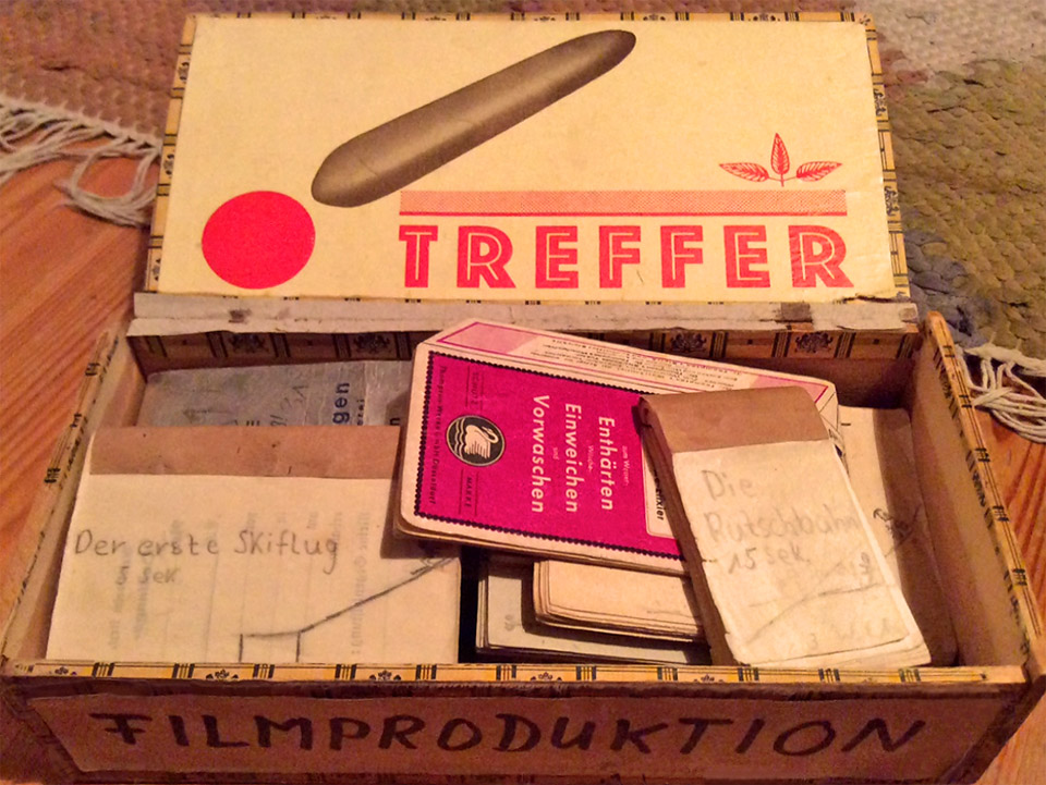Geöffnete originale Zigarrenkiste mit darin liegenden Daumenkinos und der Frontbeschriftung "Filmproduktion" die im Film "Zur Sache Schätzchen" gezeigt wurde